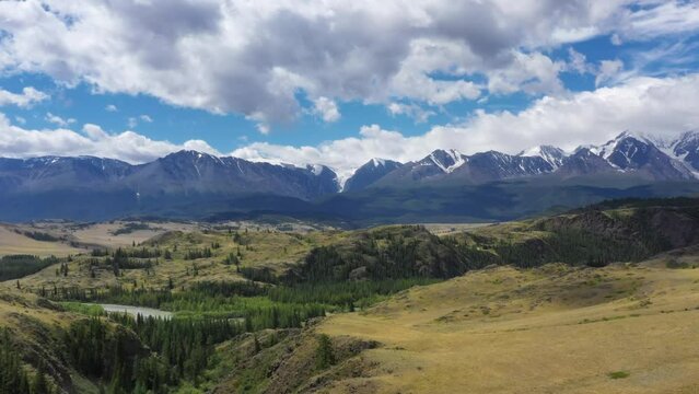 Aerial video of hills and Altai mountains in Kurai area with North Chuisky Ridge on background.