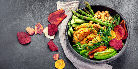 Vegan buddha bowl. Bowl with  vegetables, Zucchini fritters and vegetables chips.