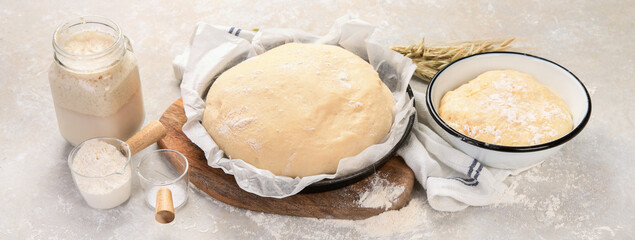 Raw dough pastry in a bowl on neutral background.