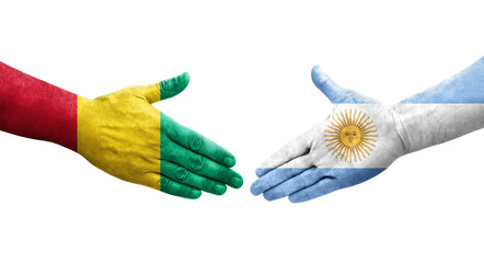 Handshake between Argentina and Guinea flags painted on hands, isolated transparent image.