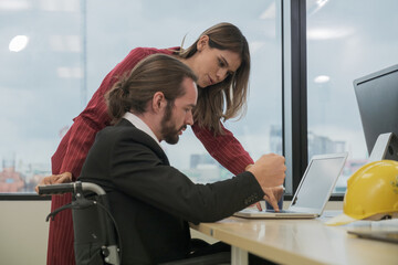 Colleagues of business people working with disabled colleagues and discussing work in the office.