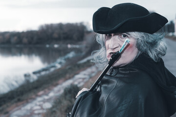 portrait armed dark evil character holding weapon outdoors cloudy evil concept