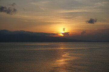 Beautiful sunrise and dramatic sky at the beach in Banyuwangi, East Java, Indonesia.