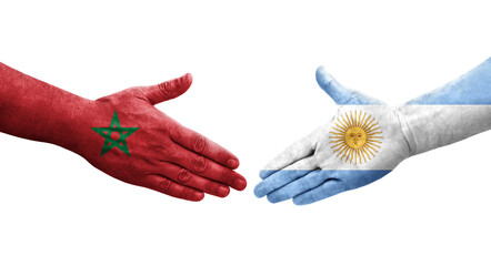 Handshake between Argentina and Morocco flags painted on hands, isolated transparent image.