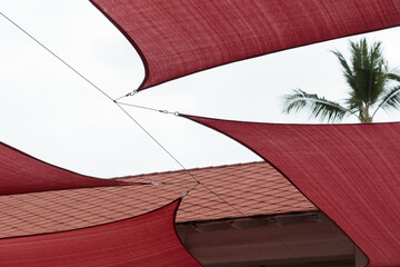 Giant red sun shades stretched over shopping plaza in Kona shopping village - 4