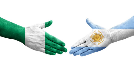 Handshake between Argentina and Nigeria flags painted on hands, isolated transparent image.