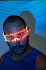 portrait of man with futuristic glasses with orange lights and futuristic background