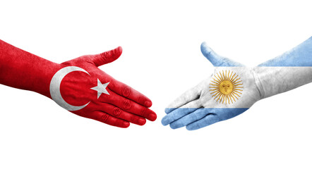 Handshake between Argentina and Turkey flags painted on hands, isolated transparent image.