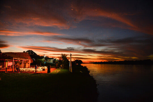 The preparation for an itinerant film exhibition on the banks of the Guapor&eacute;-Itenez river below a beautiful twilight, Versalles, Beni Department, Bolivia, on the border with Rondonia state, Brazil