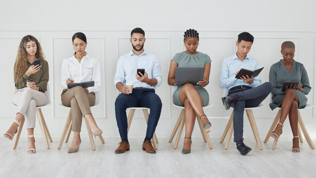 Business people, diversity and waiting room in networking or social media at the office with technology in the workplace. Diverse group of creative workers for interview, line and company recruitment