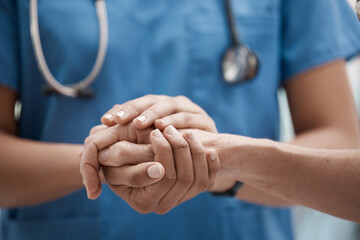 Hand holding, staff and hospital community with trust, support and hope in a clinic. Healthcare nurse, medical doctor and workers hands together to show work solidarity and team comfort care