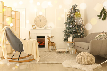 Interior of light living room with Christmas tree and reindeer near fireplace