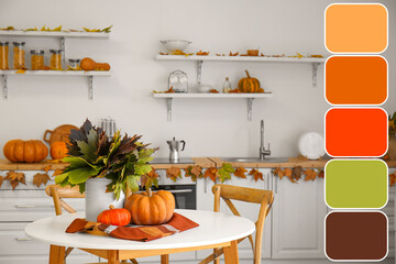 Vase with autumn leaves and fresh pumpkins on table in kitchen. Different color patterns