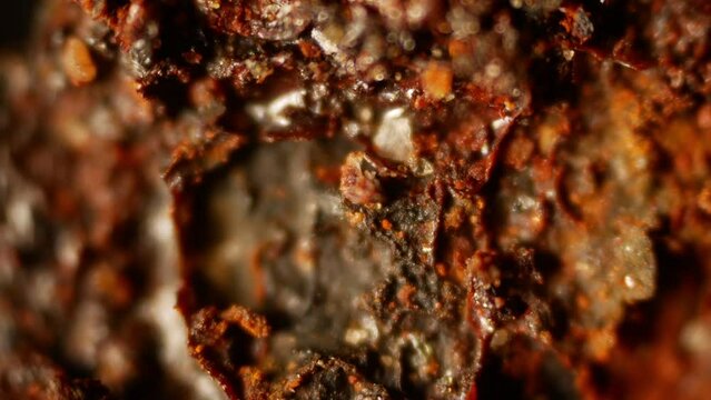 Iron oxide surface. Rusted metal under microscope. Thin sheet of galvanized steel after 15 years of car operation. Burning iron. Rusted metal