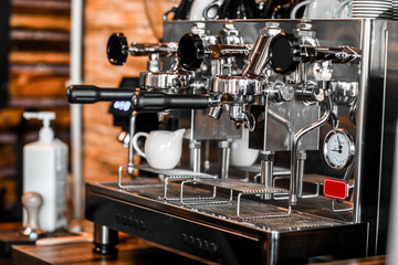 Fototapeta na wymiar Modern coffee machine on table in cafe, closeup