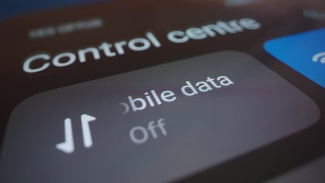 Motorized macro moving shot of turning off mobile data on a smartphone, shot with macro probe lens