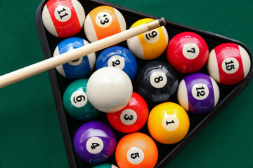 Billiard balls in triangle and cue on table