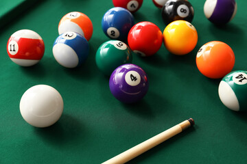 Colorful billiard balls with cue on table, closeup - obrazy, fototapety, plakaty