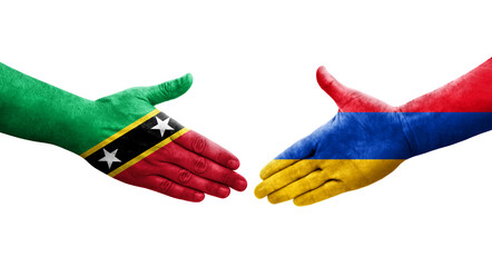 Handshake between Armenia and Saint Kitts and Nevis flags painted on hands, isolated transparent image.