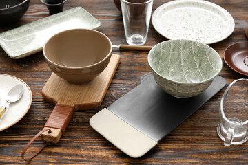 Many different tableware on wooden background