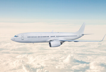 White passenger jet plane fly in the air above the clouds