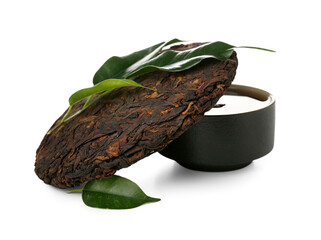 Dry pressed puer tea with cup and leaves on white background