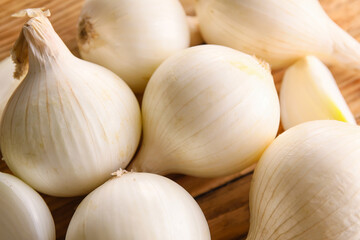 White onion on wooden table, closeup