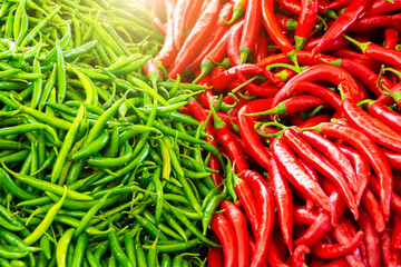 Green peppers and red hot peppers are laid out on the counter of the market selling vegetables. natural texture border.