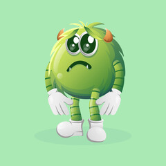 Cute green monster with sad expression