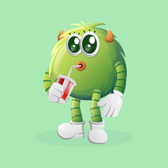Cute green monster drinking soda, cola