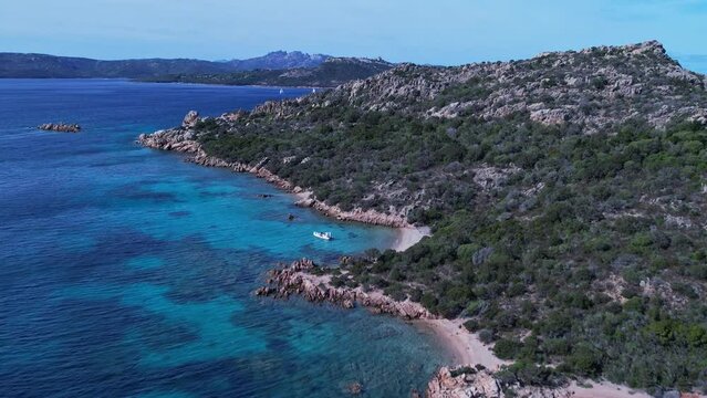 Birds eye view of the majestic cliffs beside coastline of beach and low tides moving towards them.