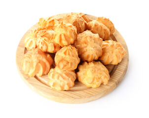Wooden board with tasty eclairs on white background