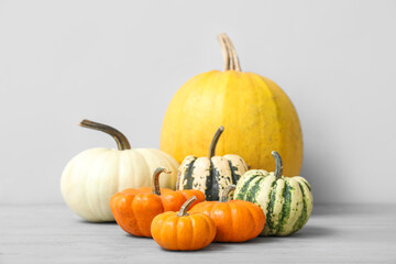 Different Halloween pumpkins on light background