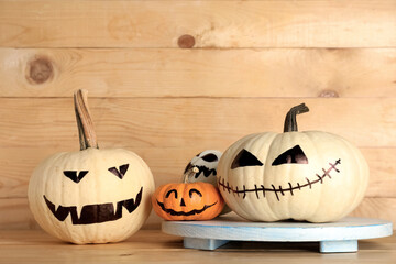 Different Halloween pumpkins on wooden background