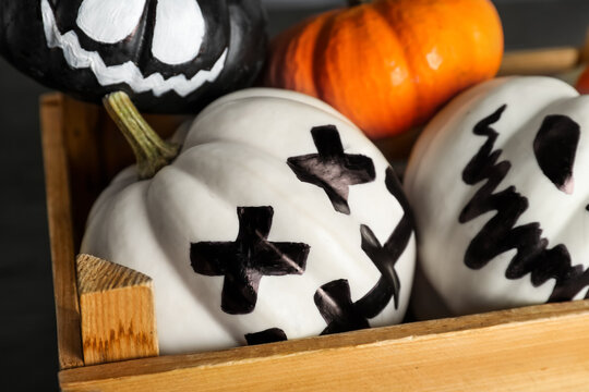 Wooden box with Halloween pumpkins, closeup