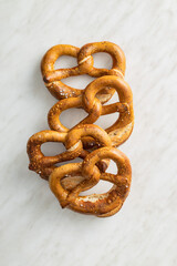 Baked bavarian pretzels on white table.