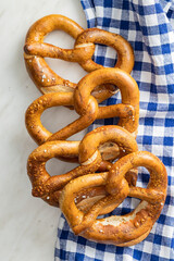 Baked bavarian pretzels on checkered napkin.
