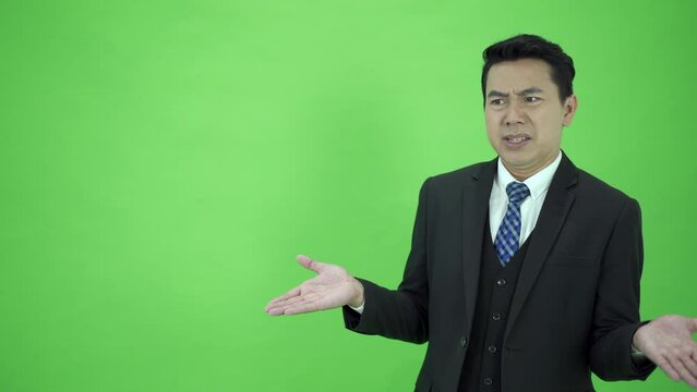 Businessman on Chroma Green Screen showing unhappy face.