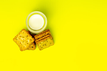 Obraz na płótnie Canvas box or square shape biscuits with mixed vegetable ingredients, with a glass of milk and spilled milk