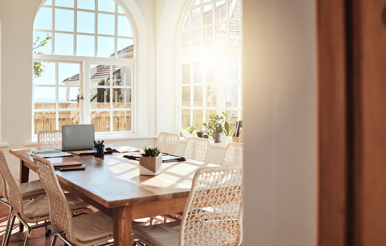 Empty, wood and luxury dining room interior design in summer at a hotel, house or apartment with an elegant style. Hardwood table, furniture and chairs with sunlight from window in a modern home