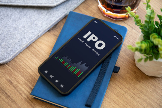 phone with IPO stocks purchase app on screen in office