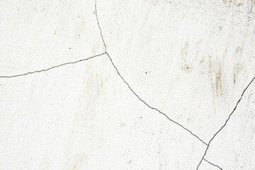 Old white concrete wall with cracks for the background.