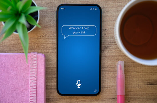 phone with app personal assistant on screen background of table