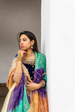 Pensive ethnic woman in traditional clothes