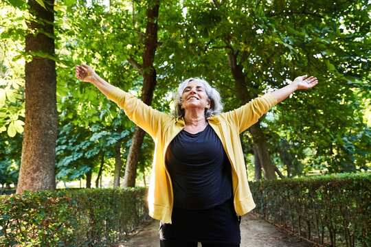 Senior sportswoman breathing fresh air in park