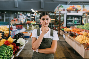 Woman seller of fruit at the market near the counter