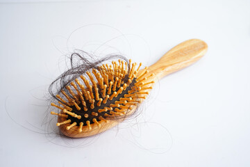 Hair loss fall with comb brush isolated on white background.