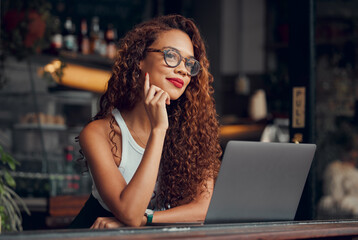 Black woman, working at cafe on laptop and remote work online as digital freelance employee. Modern professional businesswoman, writing web design blog and internet connection to work at coffee shop