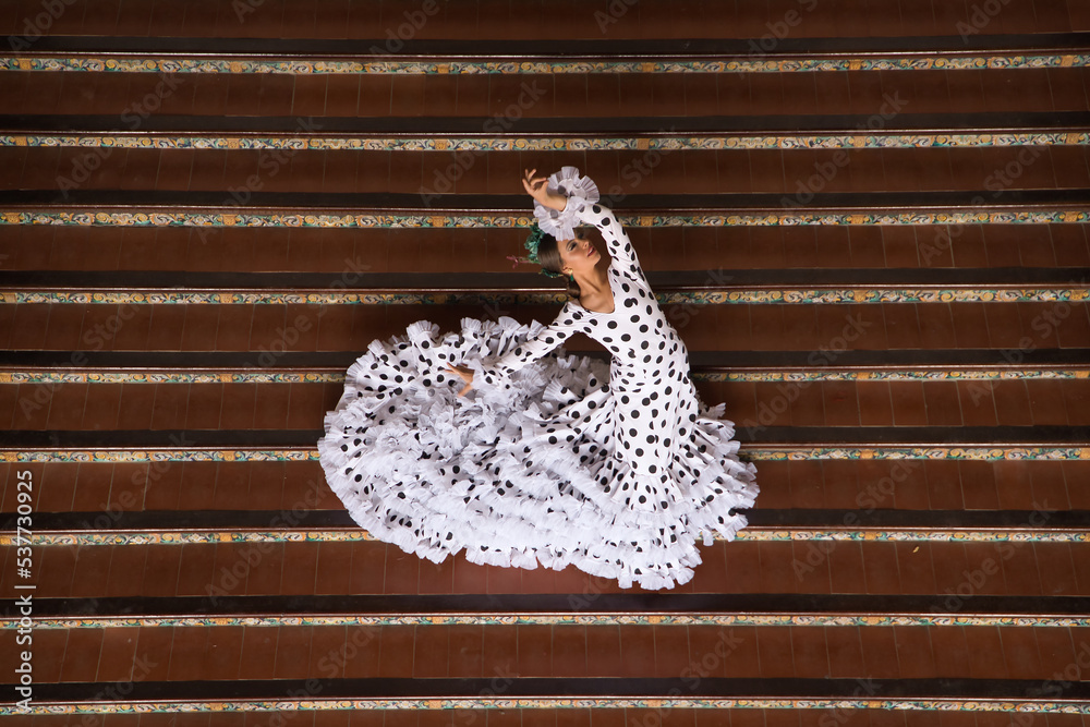 Sticker young teenage woman in white dance suit with black polka dots and green carnations in her hair doing