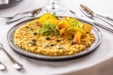 Creatively cooked pumpkin risotto served on a ceremonially prepared table in the hotel restaurant